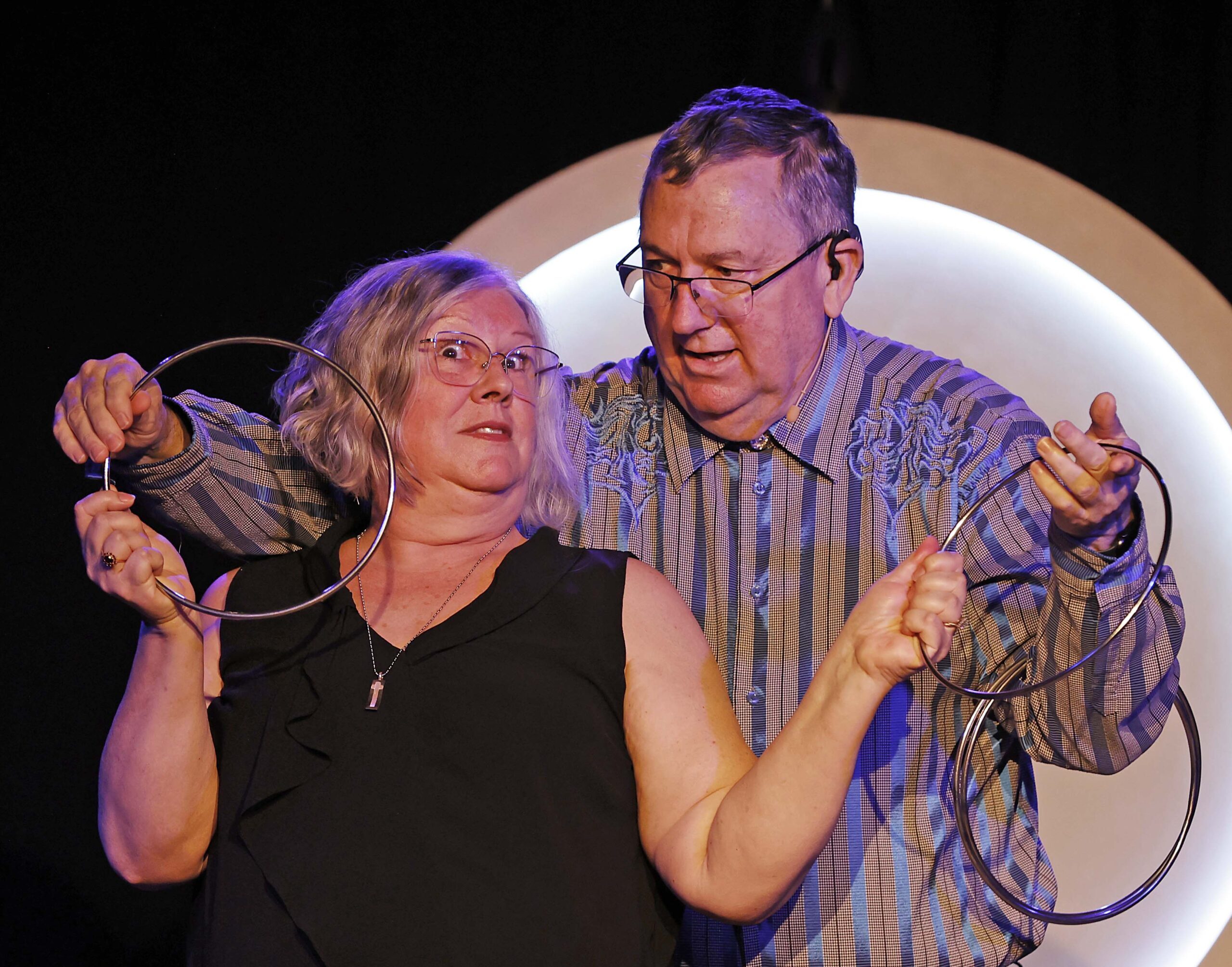 Oonaugh reacting with delight as Greg Wood performs a linking-rings illusion