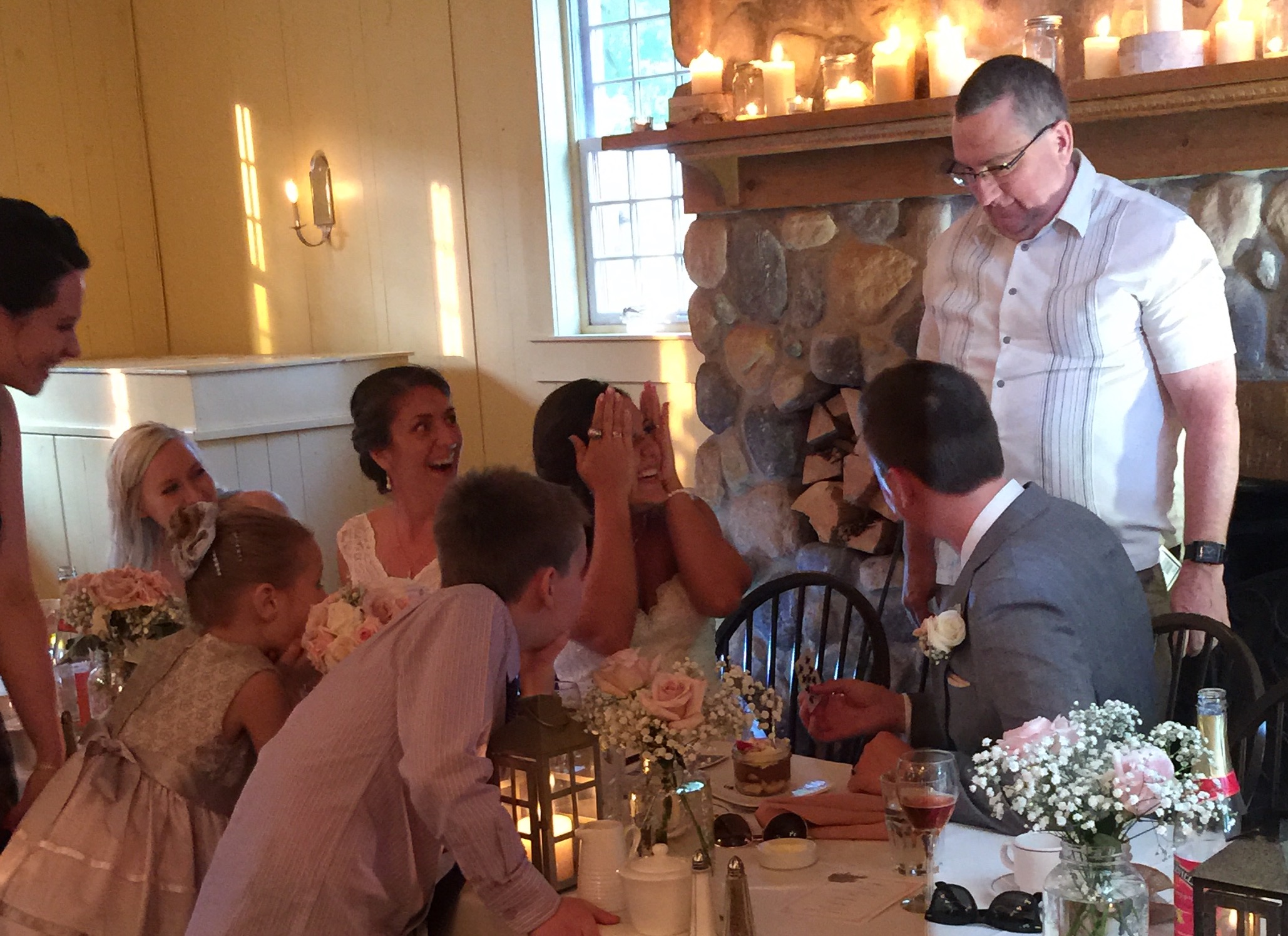 Winnipeg wedding magician Greg Wood entertaining the bride, groom, and laughing guests